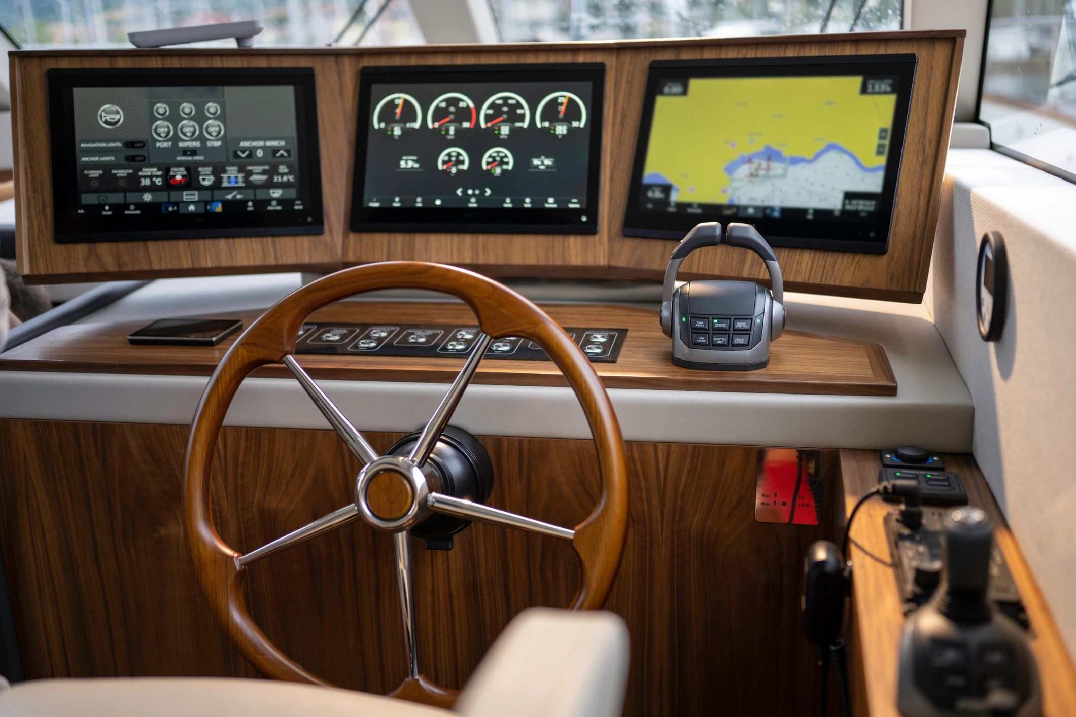 Yacht helm with steering wheel and instruments, suggesting on-water testing