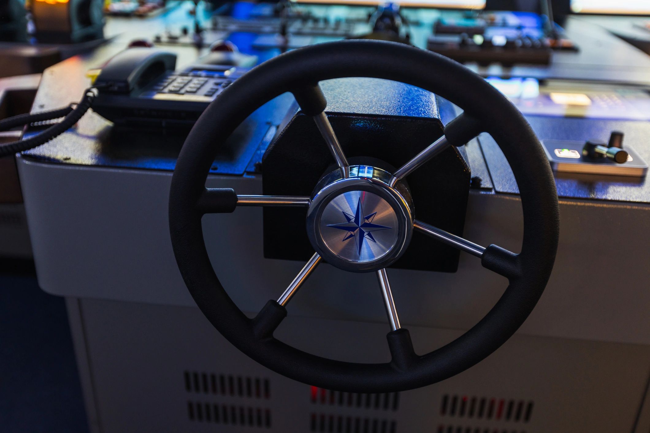 Close-up of a boat helm with marine navigation instruments