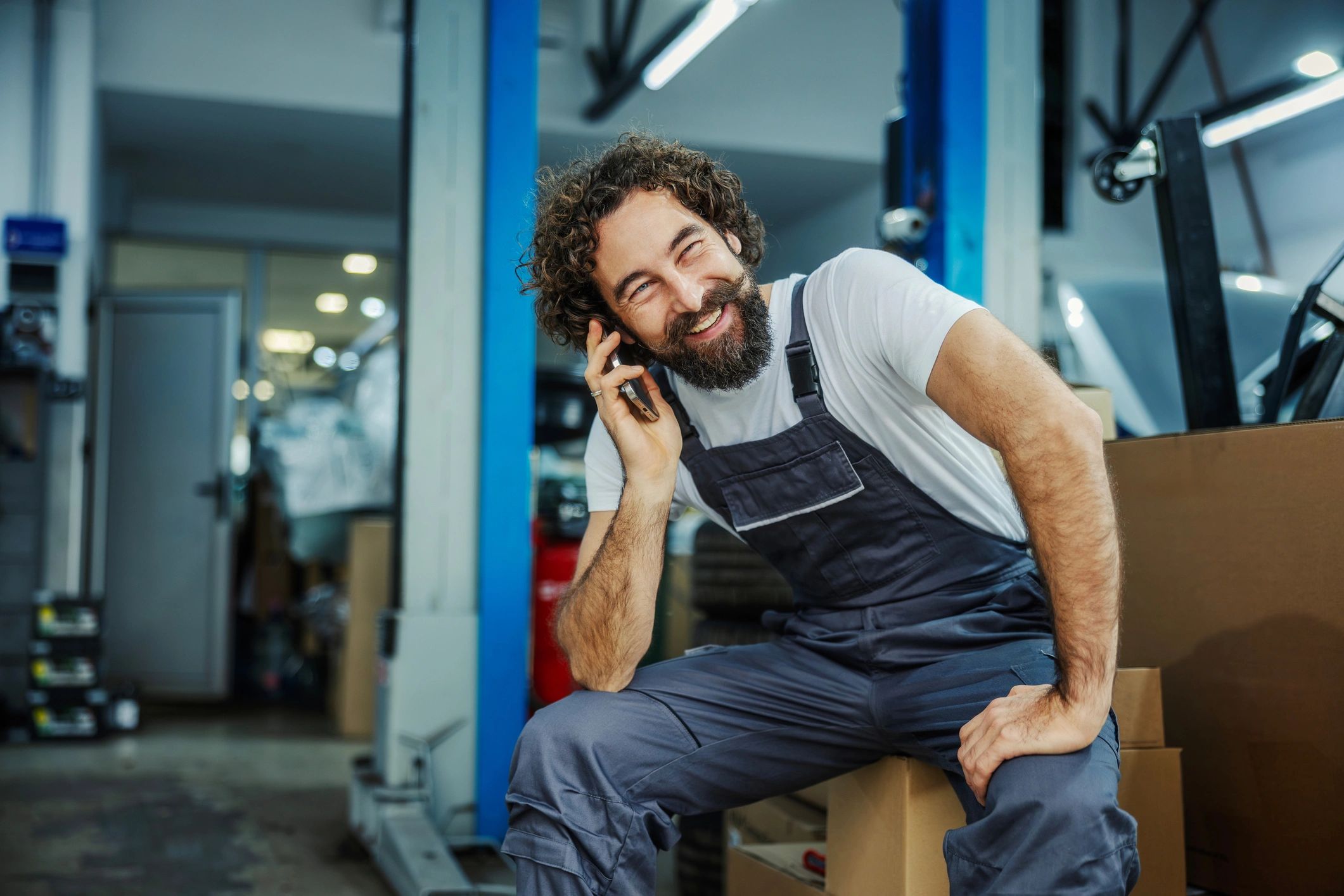Mechanic taking a call in a workshop