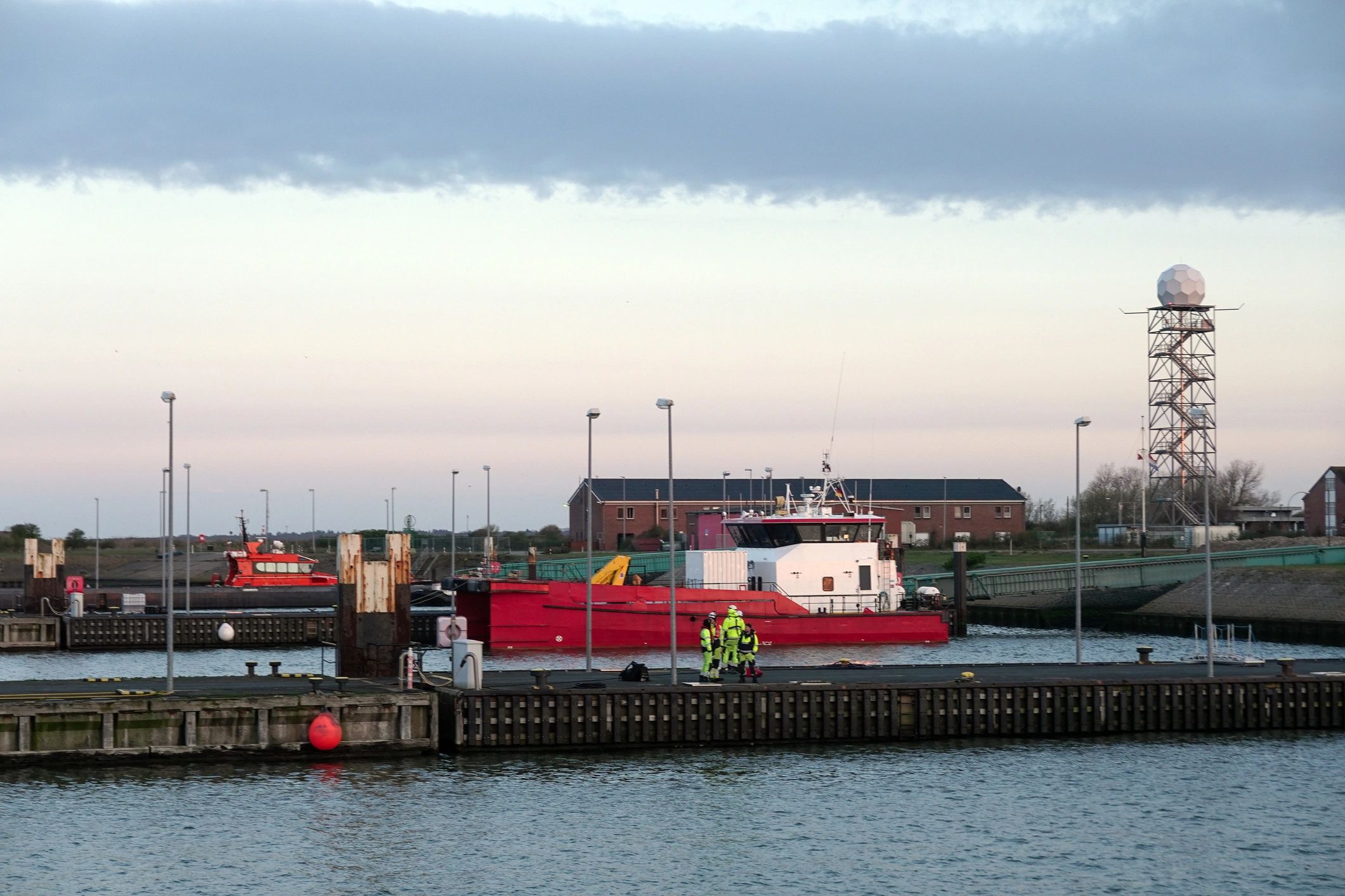 Coast guard-style service vessel in harbor at twilight