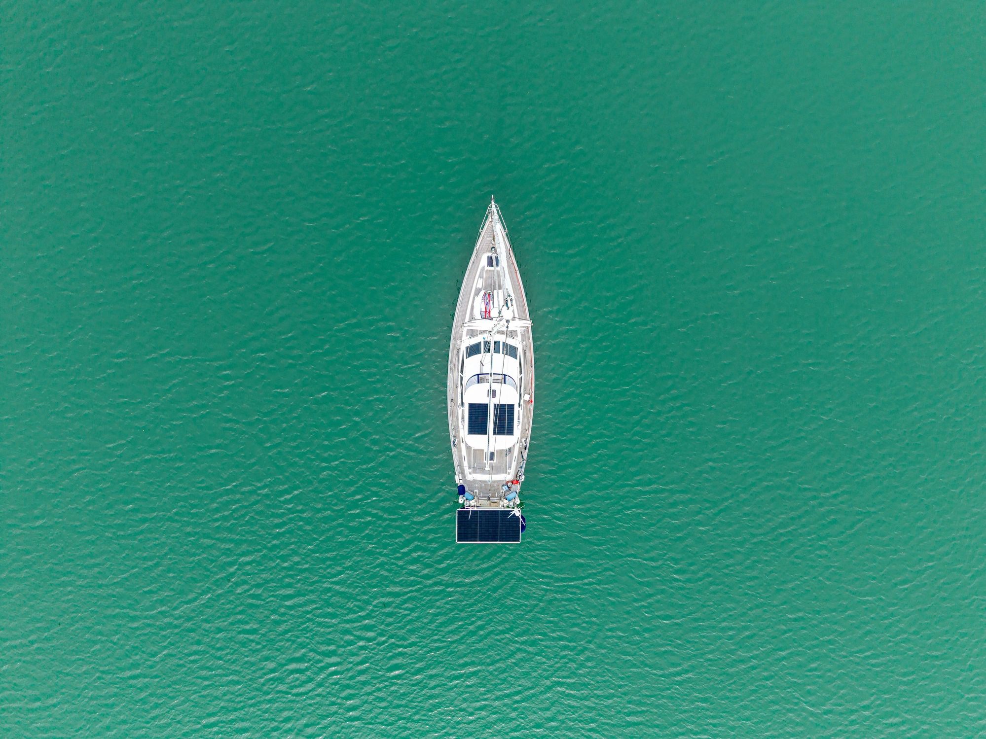 Aerial view of a modern sailboat on blue water