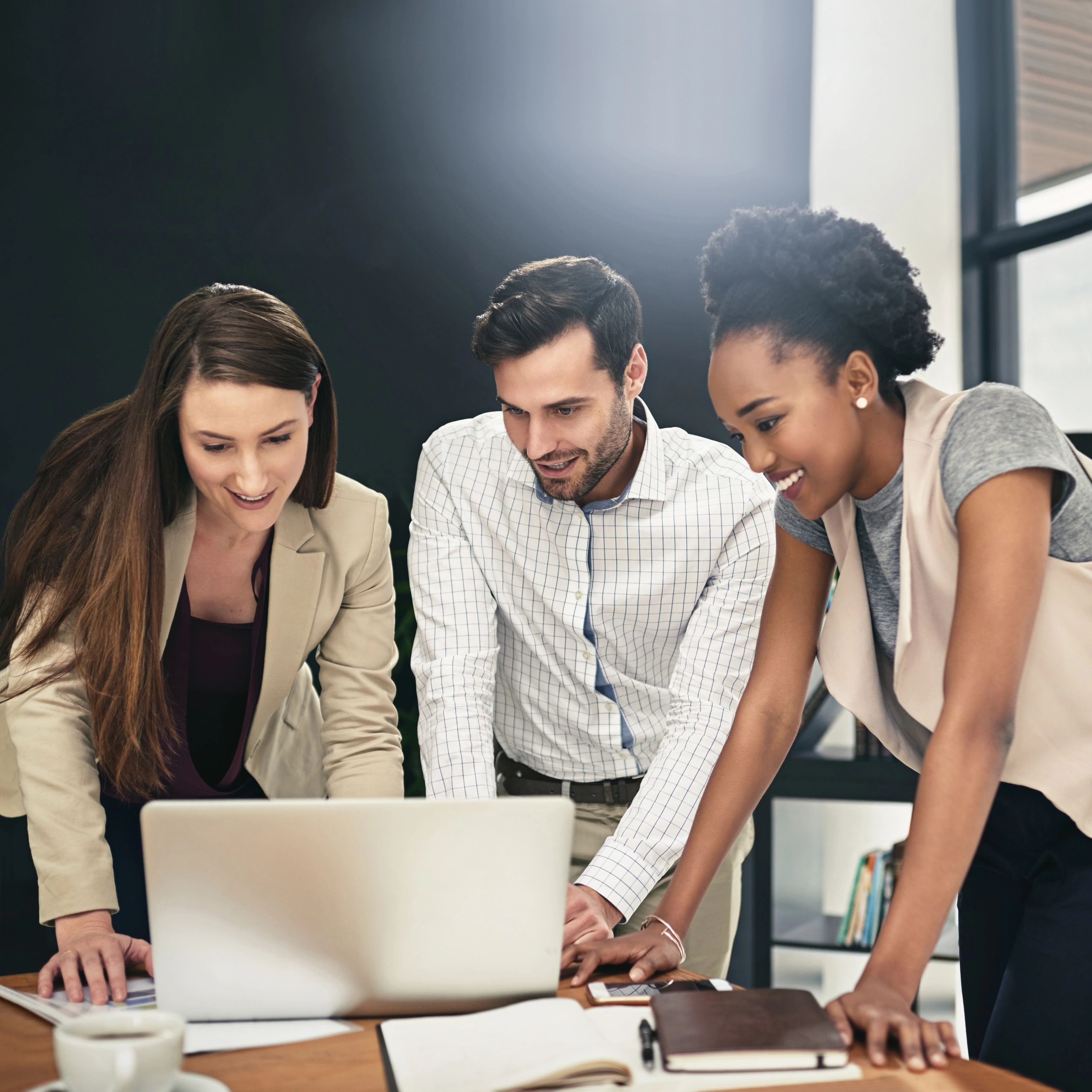 Colleagues collaborating on a laptop